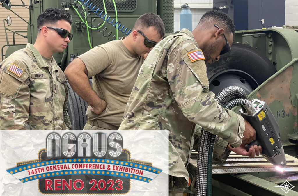 three national guard men stand around a green truck while one uses laser cleaning system to remove paint